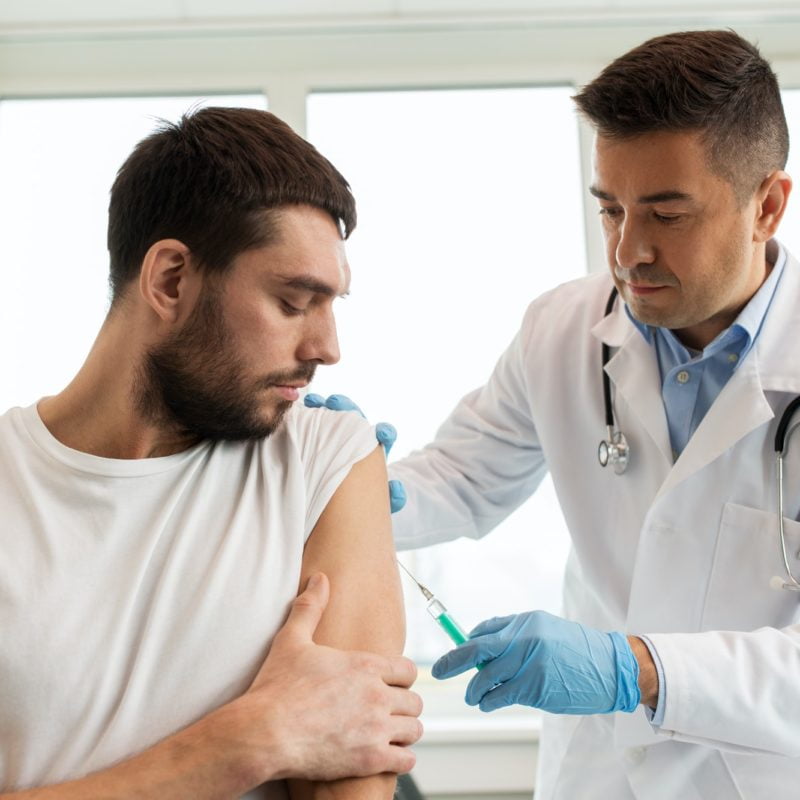 patient and doctor with syringe doing vaccination